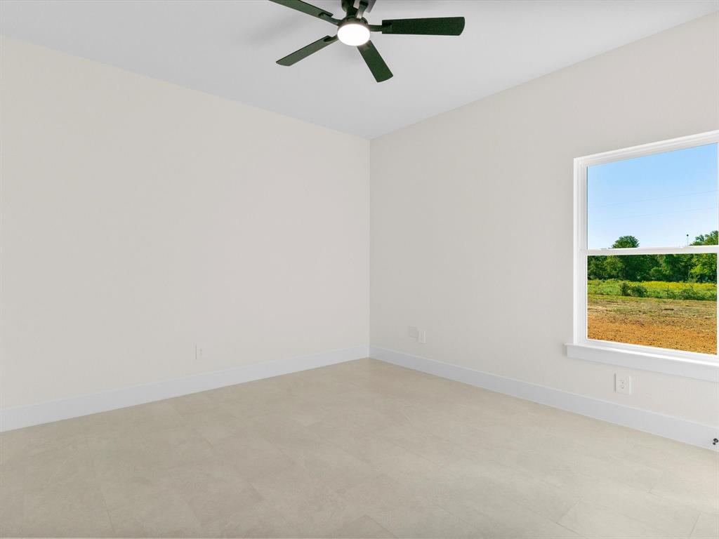 1623 County Road 4764 Boyd, TX 76023 - Photo 19 of 29 an empty room with a window and a ceiling fan
