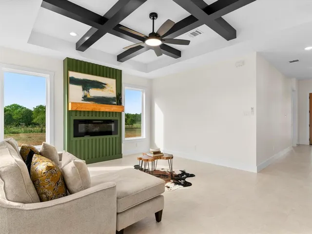 a living room with furniture and a floor to ceiling window