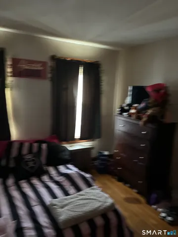 a bathroom with a sink a toilet a mirror and shower