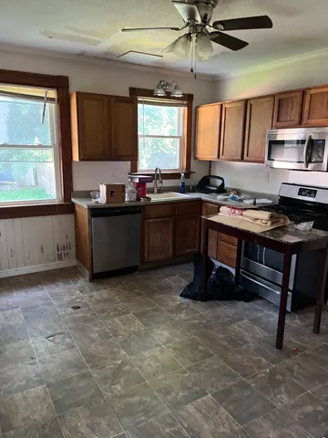 a room with furniture a window and appliances