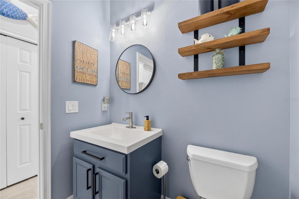 5721 Sea Turtle Place Apollo Beach, FL 33572 - Photo 42 of 80 a bathroom with a toilet a sink and a mirror