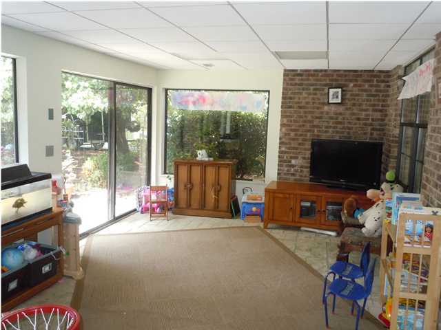 402 Olde Post Road Niceville, FL 32578 - Photo 9 of 13 a living room with furniture a flat screen tv and a fireplace