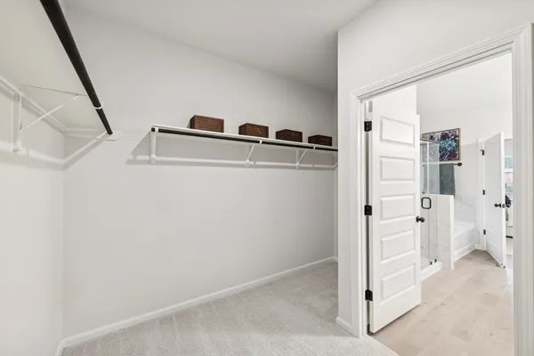 a view of closet with wooden floor