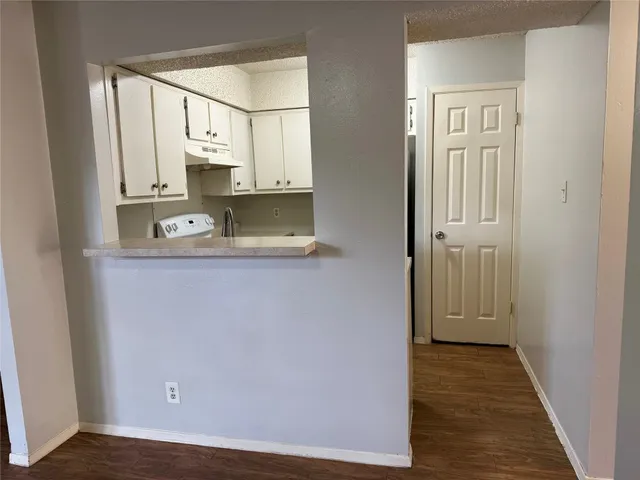 a view of a kitchen from the hallway