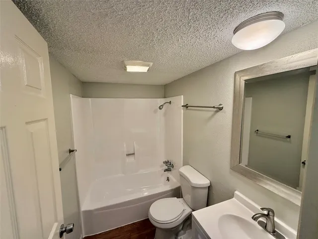 a bathroom with a toilet a sink and bathtub