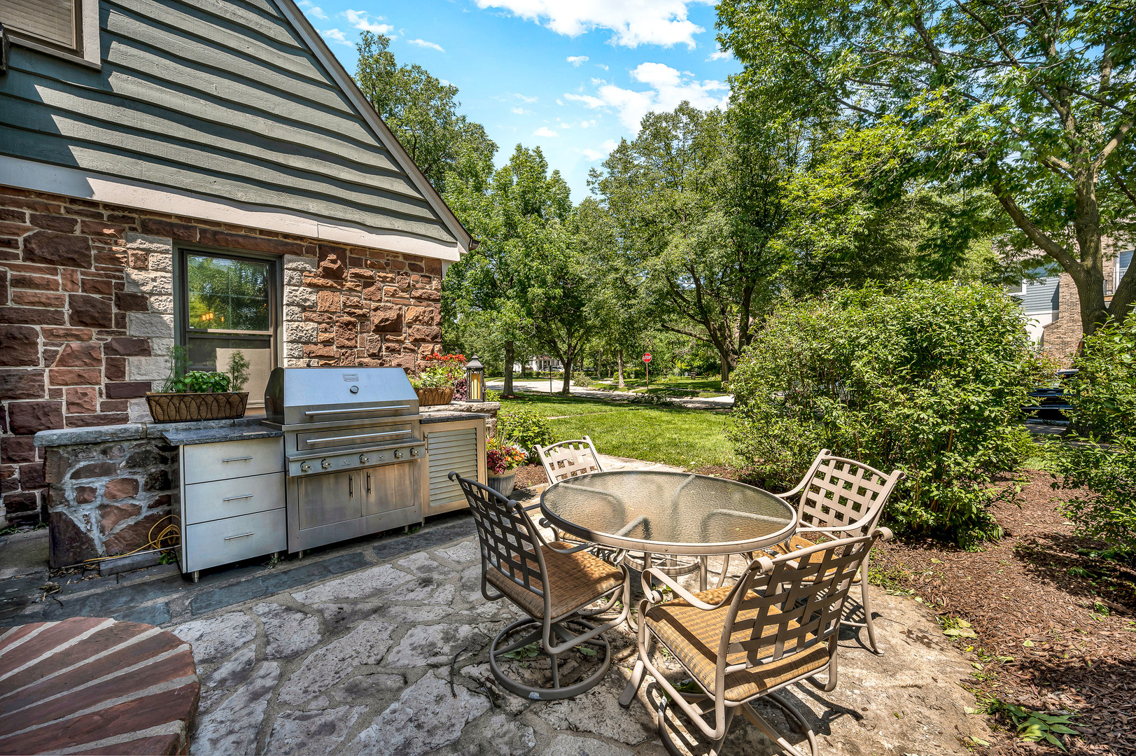 100 South Herbert Road Riverside, IL 60546 - Photo 3 of 30 a patio with table and chairs and potted plants