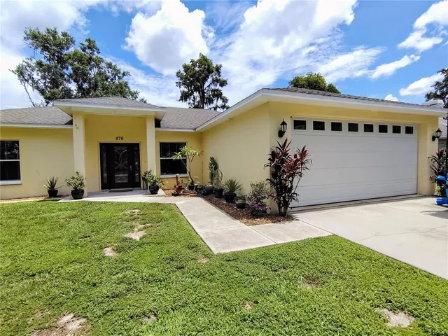 a view of a house with garden and plants