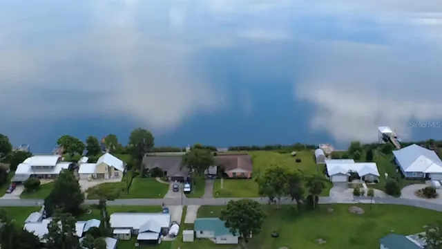 an aerial view of a house with a yard