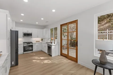 a kitchen with stainless steel appliances granite countertop a stove and a refrigerator