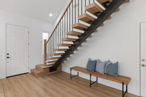 a view of entryway and hall with wooden floor