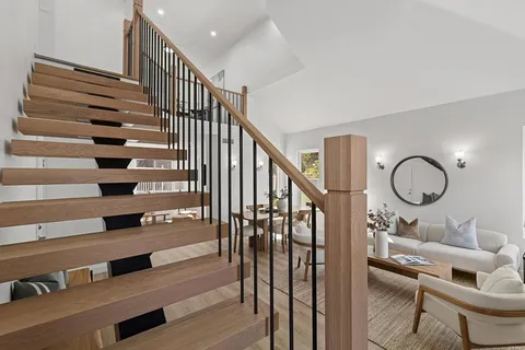 a view of entryway and hall with wooden floor