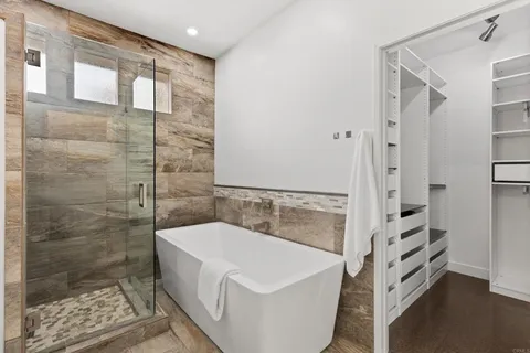 a bathroom with a bathtub and a shower