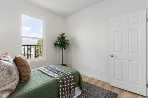 a bedroom with a bed and a window