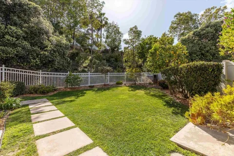 a view of a backyard with swimming pool