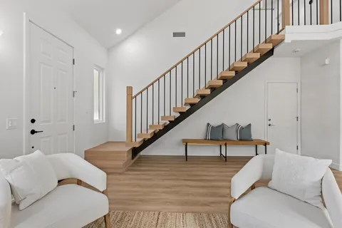 a living room with furniture and stairs