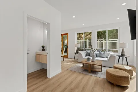 a living room with furniture and a floor to ceiling window