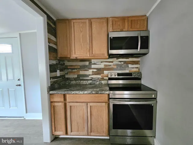 a kitchen with a stove and a microwave