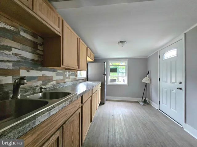 a kitchen that has a sink and a stove