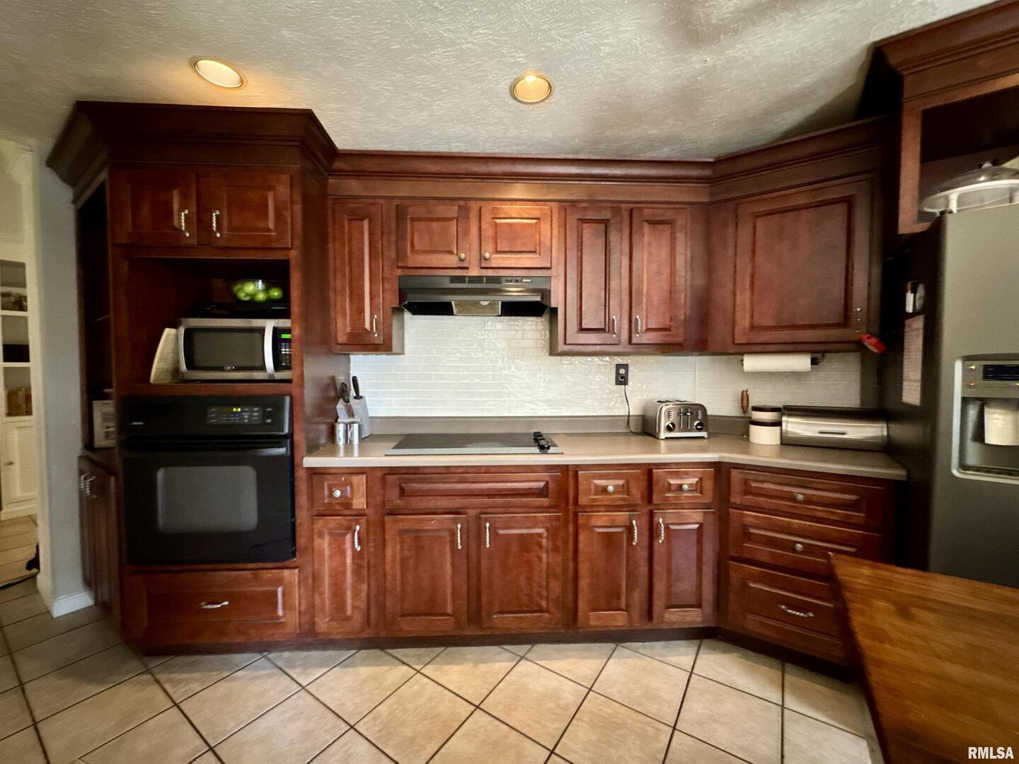 1801 Colonial Drive Marion, IL 62959 - Photo 18 of 45 a kitchen with stainless steel appliances granite countertop a stove sink and cabinets