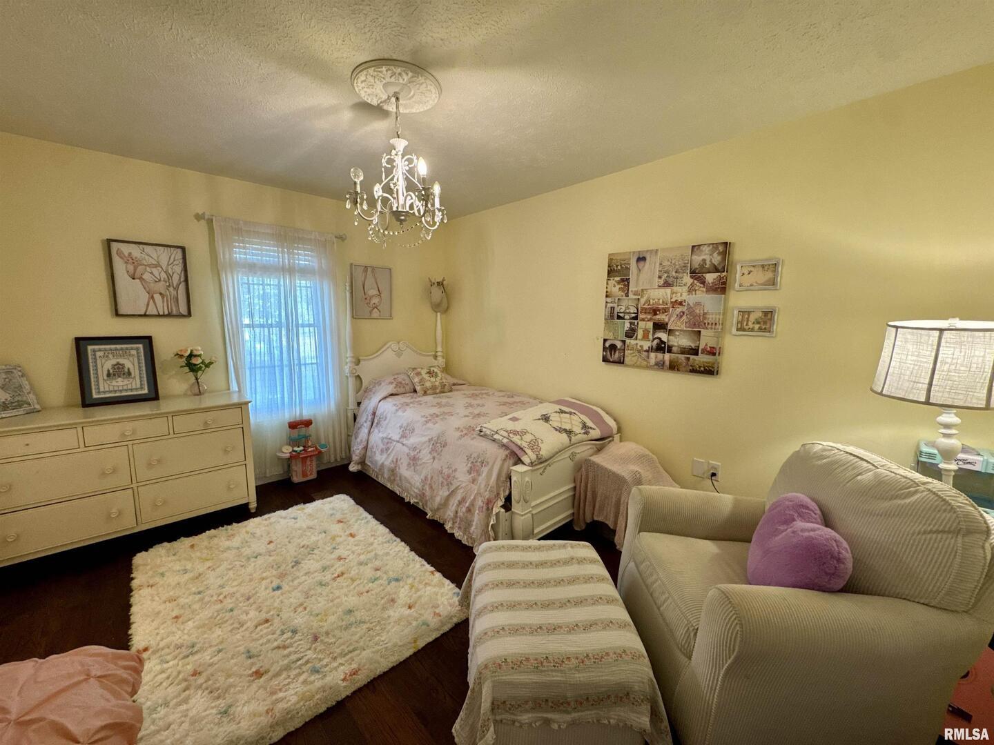 1801 Colonial Drive Marion, IL 62959 - Photo 32 of 45 a bedroom with a bed and wooden floor