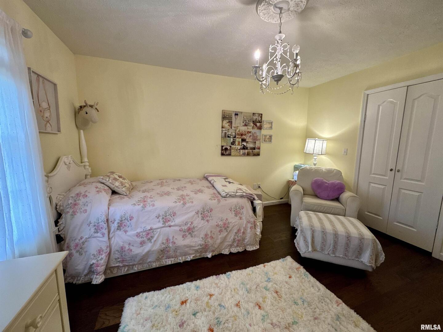 1801 Colonial Drive Marion, IL 62959 - Photo 33 of 45 a bedroom with a bed and a chandelier