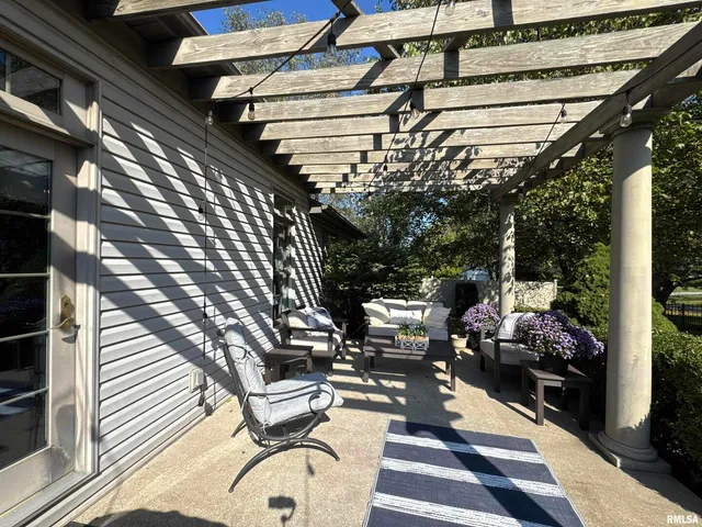 a view of a house with backyard sitting area and garden