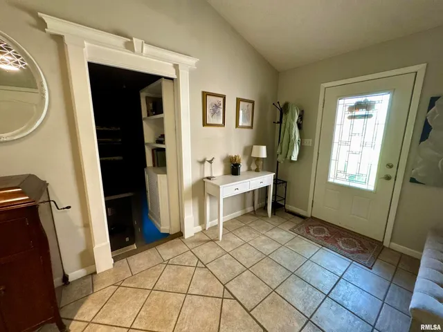 a room that has a bed and a table in it