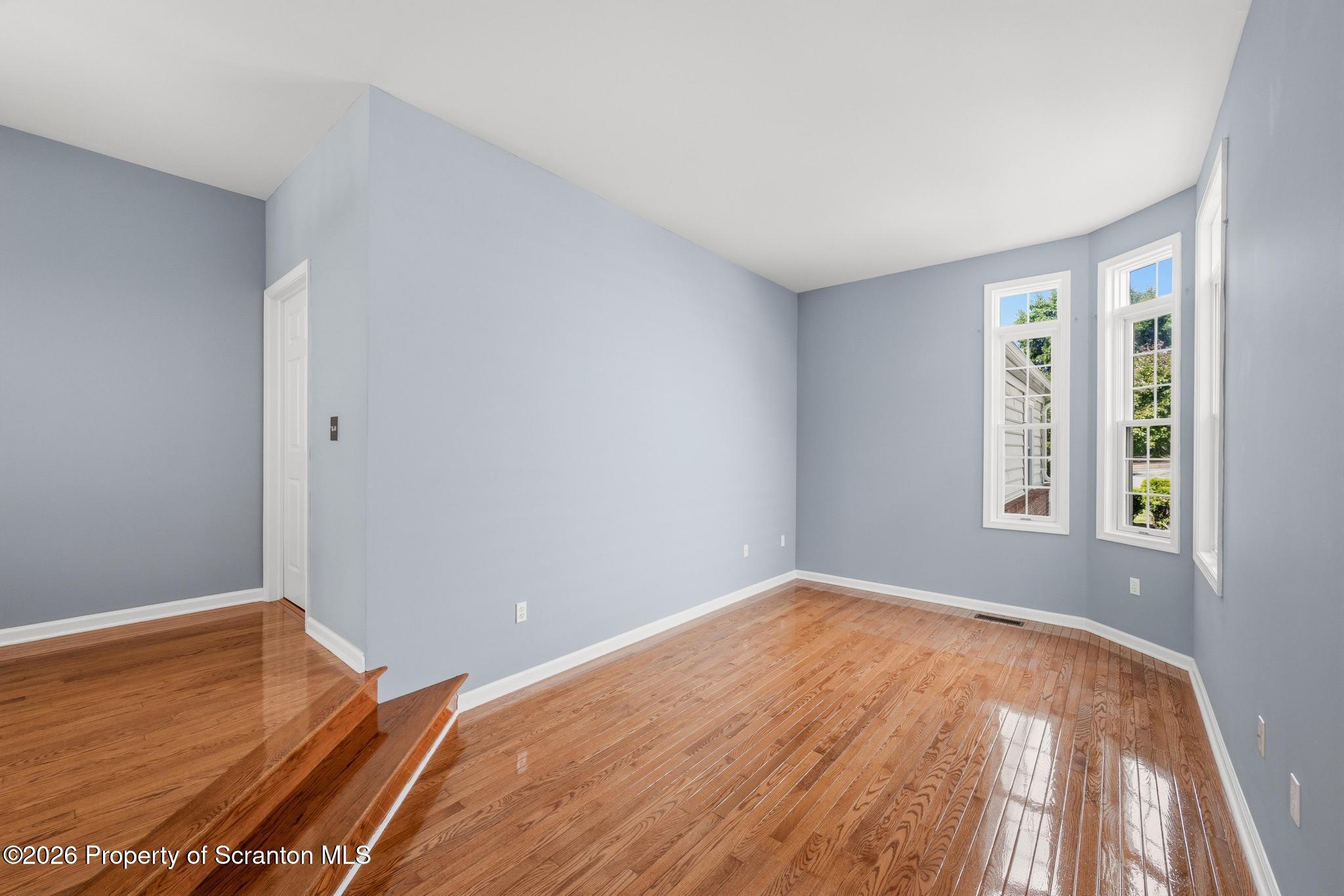 1502 Verne Cl Moosic, PA 18507 - Photo 14 of 46 an empty room with wooden floor and windows