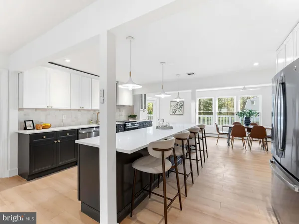 a kitchen with stainless steel appliances a sink stove and cabinets