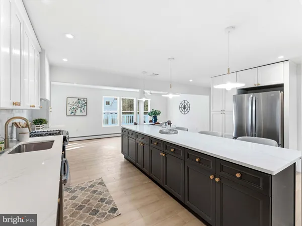 a large kitchen with stainless steel appliances granite countertop a lot of counter space and a sink