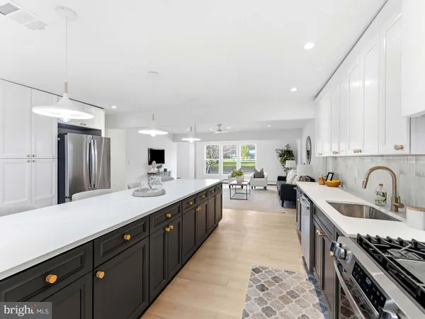 a kitchen with a sink stove and cabinets