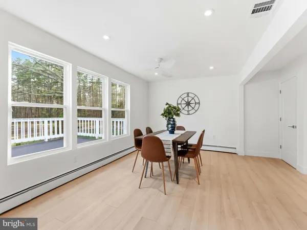 a bedroom with a large bed rug and a wooden floor
