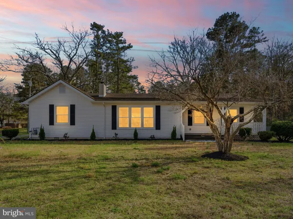 a front view of house with yard and trees