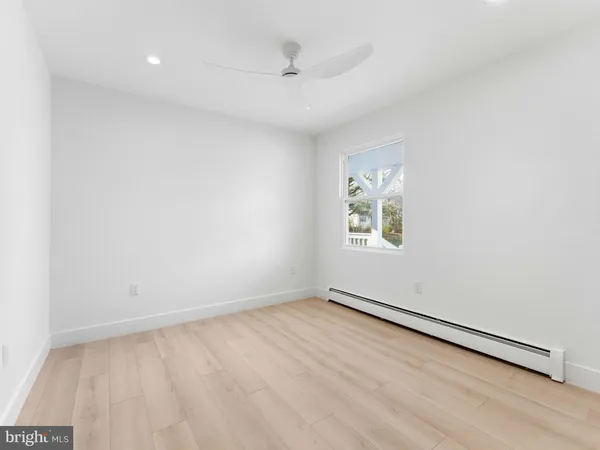 a spacious bathroom with a granite countertop sink mirror and toilet