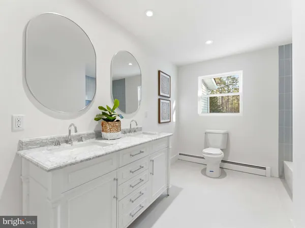 a bathroom with a toilet sink and mirror