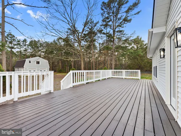 an aerial view of a house with backyard space and deck