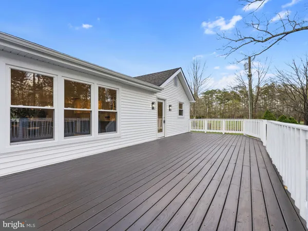 a view of a house with a yard and large tree