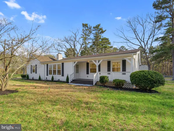 a view of a house with a wooden deck