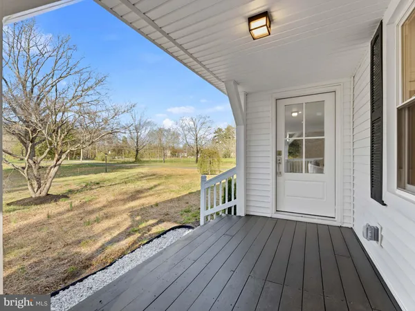 a living room with furniture and view of kitchen