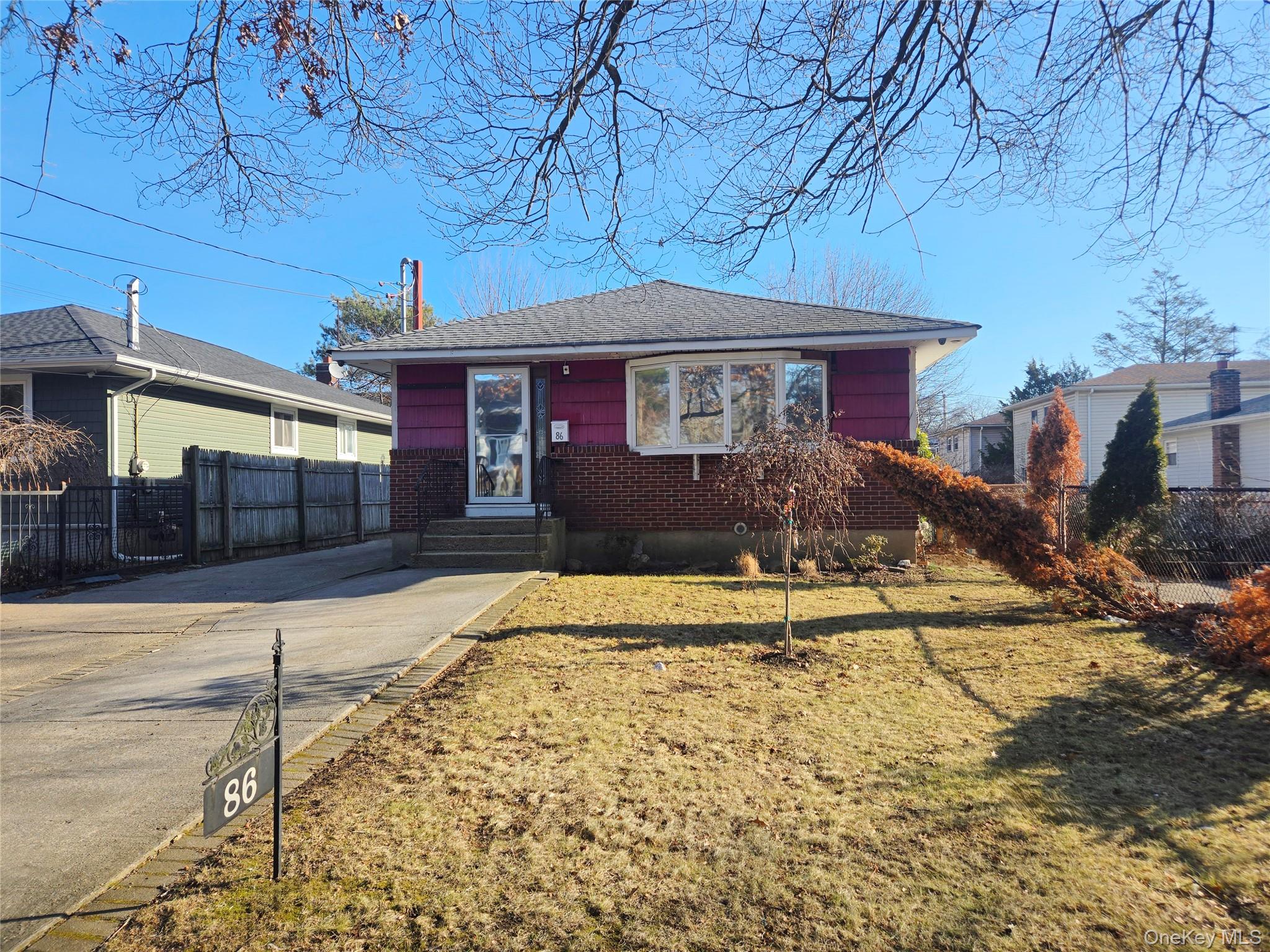 86 Decatur Street Roosevelt, NY 11575 - Photo 2 of 30 a front view of a house with a yard