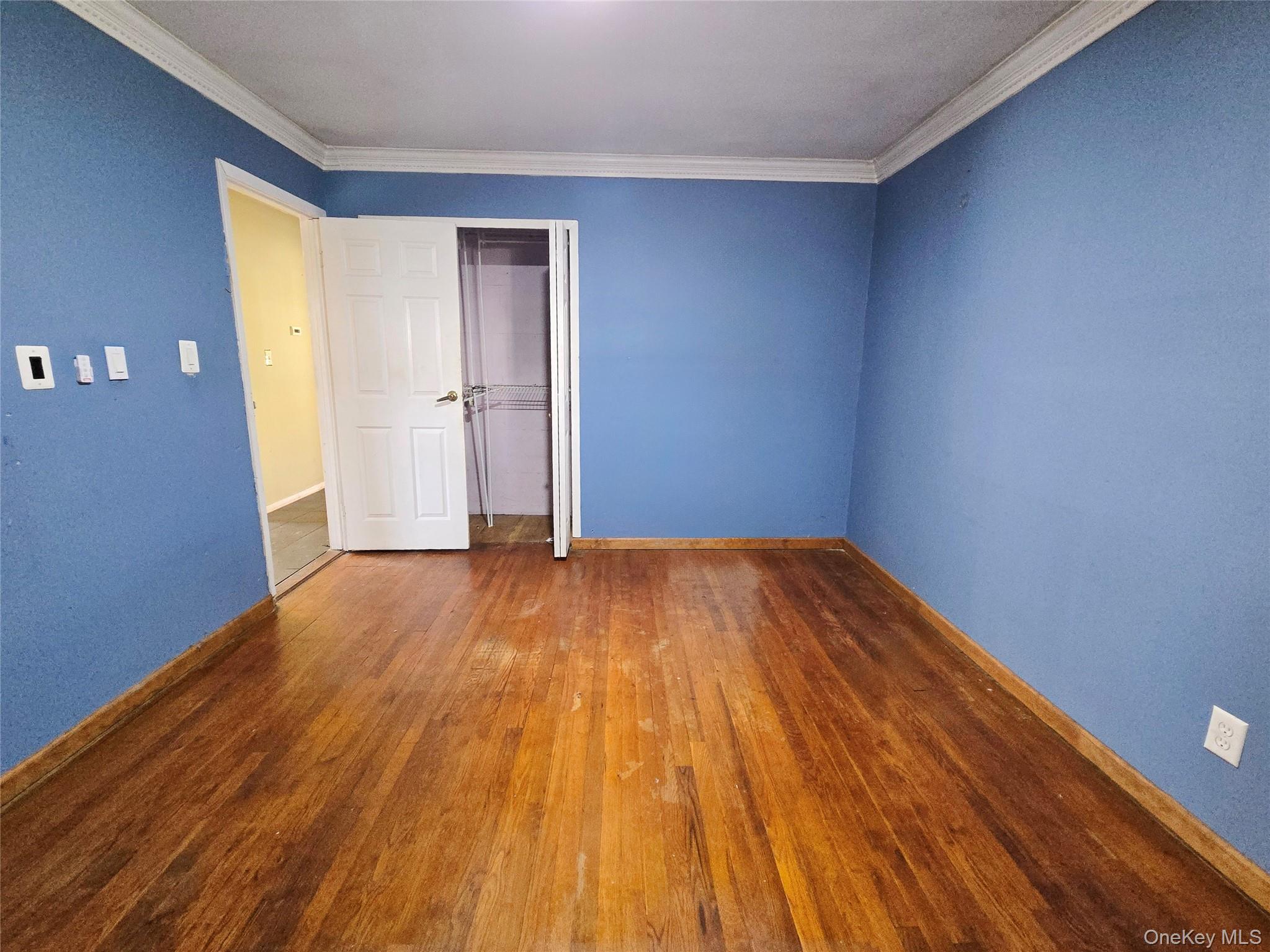 86 Decatur Street Roosevelt, NY 11575 - Photo 21 of 30 a view of empty room with wooden floor and entryway