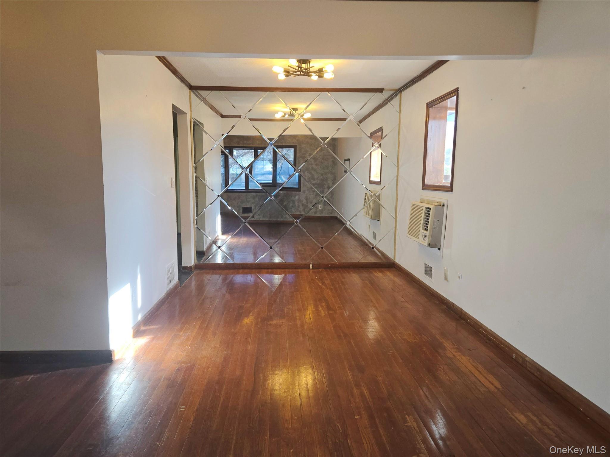 86 Decatur Street Roosevelt, NY 11575 - Photo 9 of 30 a view of entryway with wooden floor
