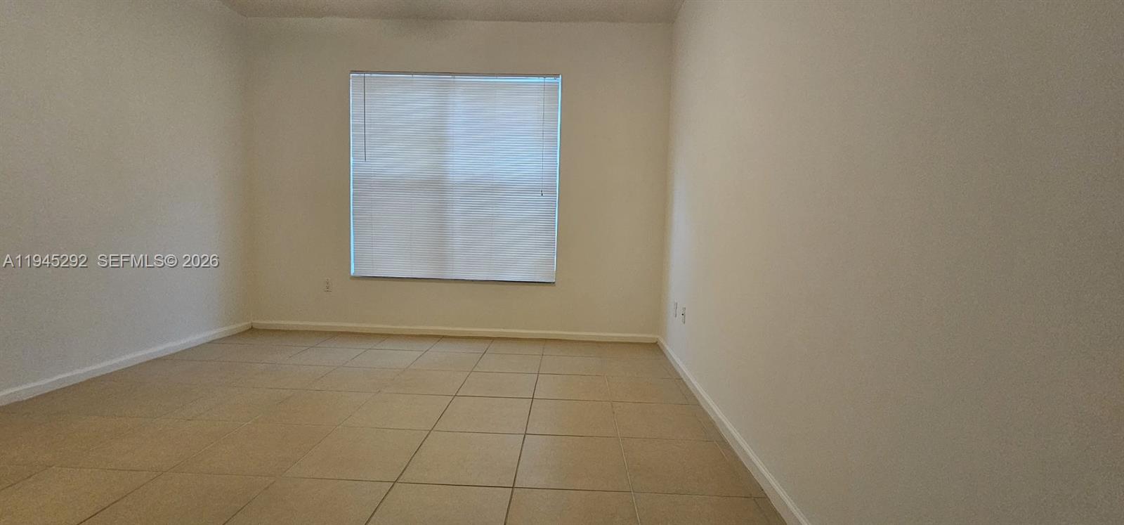 5800 West Sample Road, Unit 103 Coral Springs, FL 33067 - Photo 14 of 18 a view of an empty room with a window