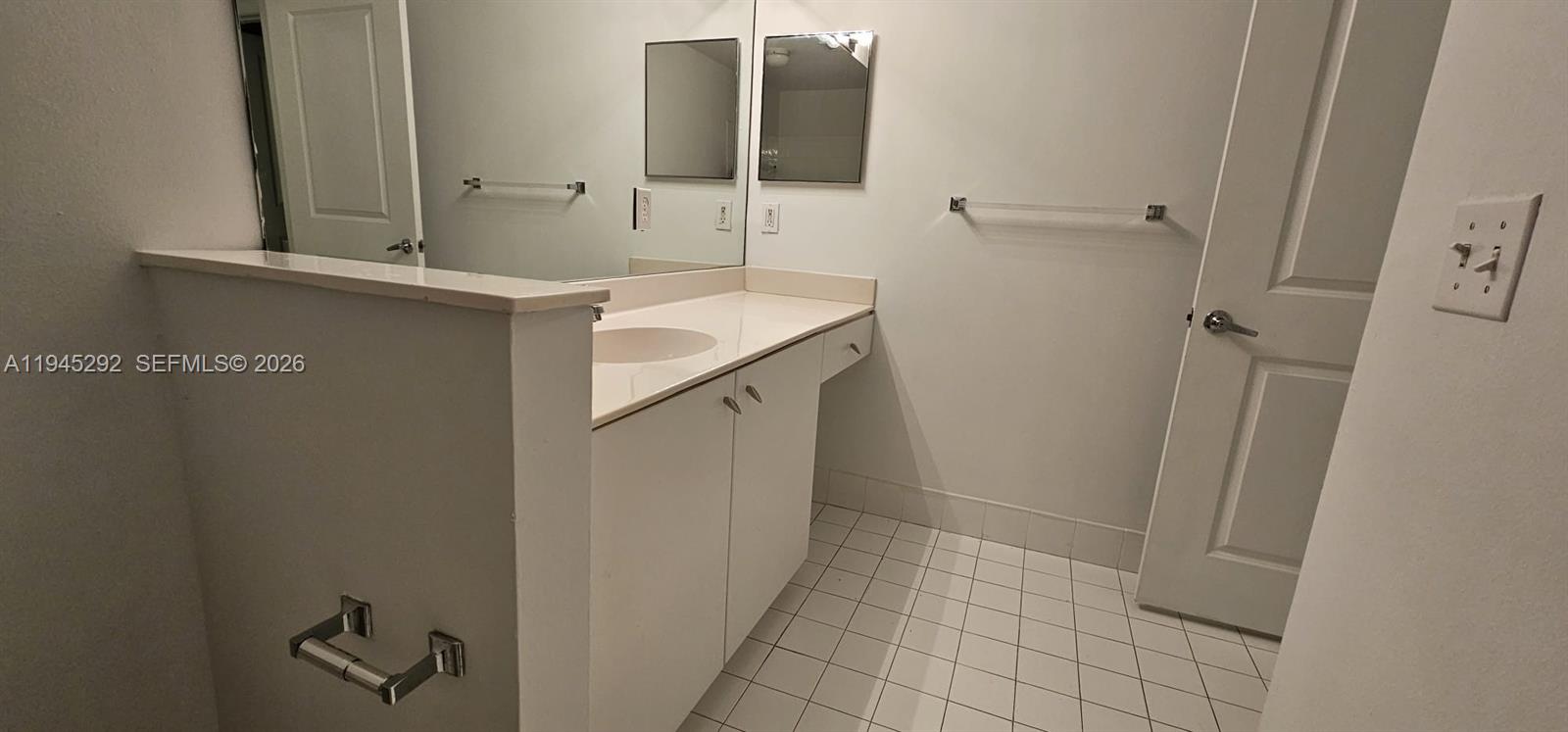 5800 West Sample Road, Unit 103 Coral Springs, FL 33067 - Photo 15 of 18 a bathroom with a sink and mirror