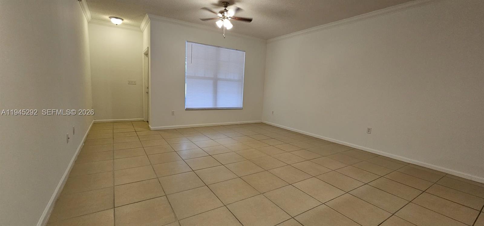 5800 West Sample Road, Unit 103 Coral Springs, FL 33067 - Photo 17 of 18 an empty room with chandelier fan