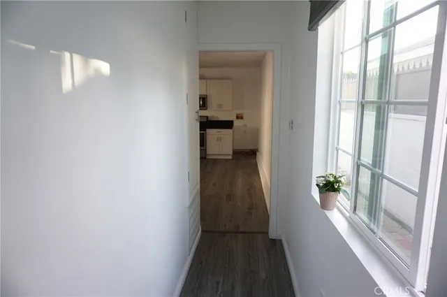 a kitchen with stainless steel appliances a refrigerator and wooden floors