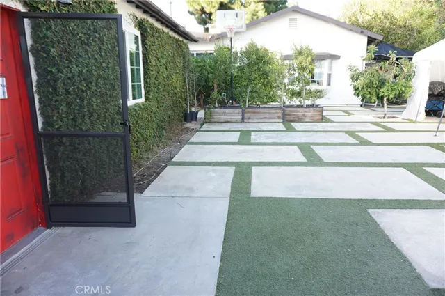 a kitchen with wooden floors and white cabinets