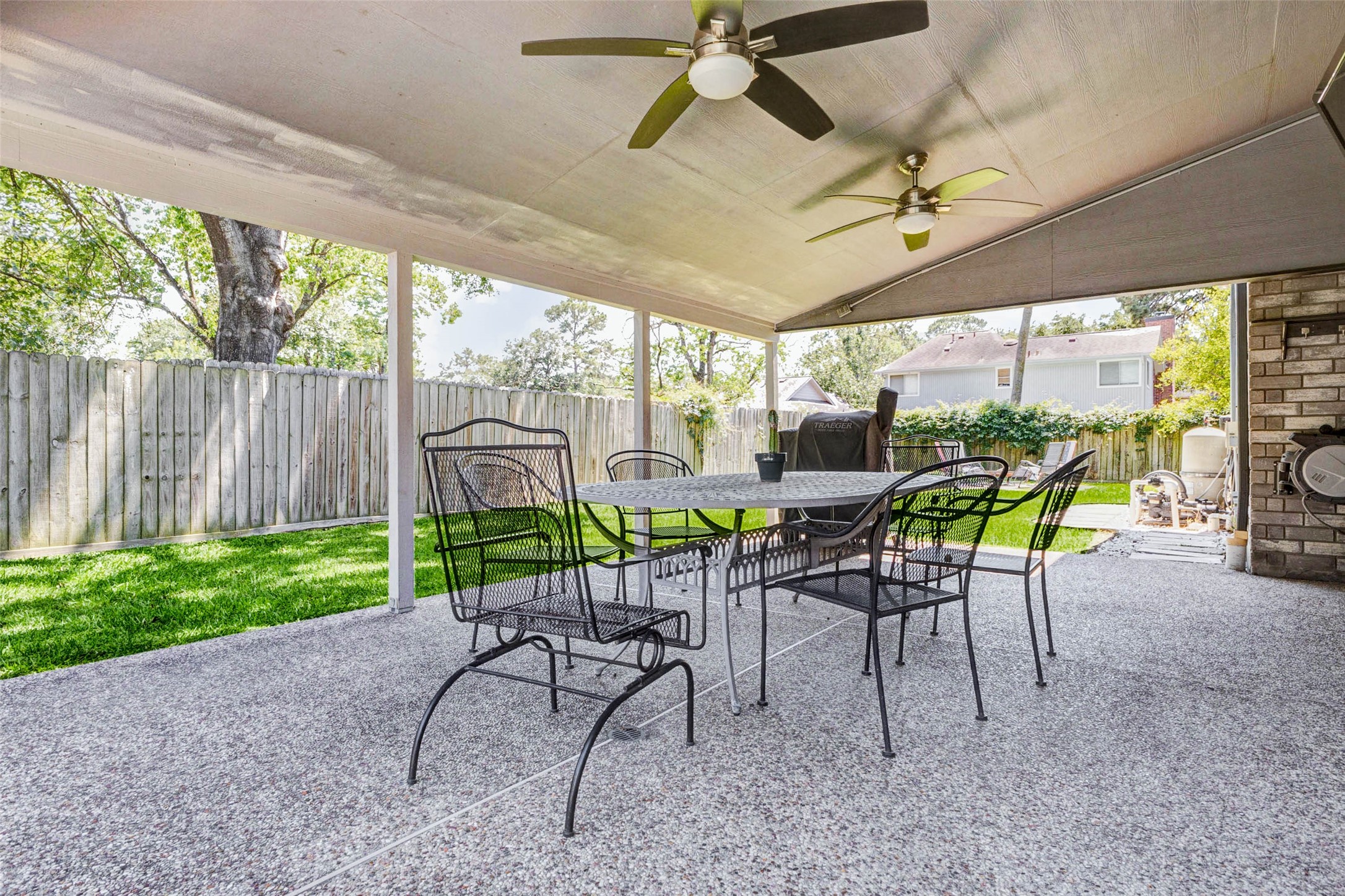 9215 Landry Boulevard Spring, TX 77379 - Photo 40 of 42 Dual ceiling fans enhance comfort and airflow beneath the expansive covered patio, creating the perfect setting for outdoor dining, entertaining, or relaxing year round.