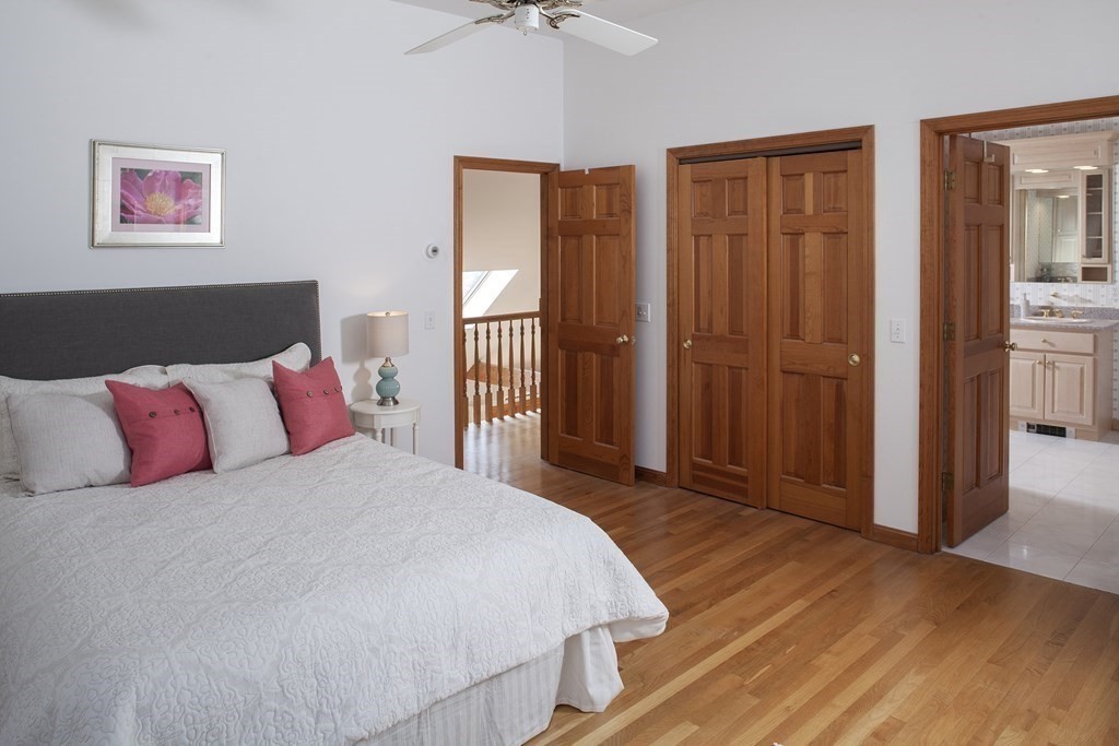 93 Beach Road Orleans, MA 02653 - Photo 18 of 28 a bedroom with a large bed and a chandelier