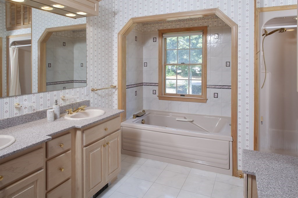 93 Beach Road Orleans, MA 02653 - Photo 19 of 28 a bathroom with a granite countertop sink mirror bathtub and next to a window